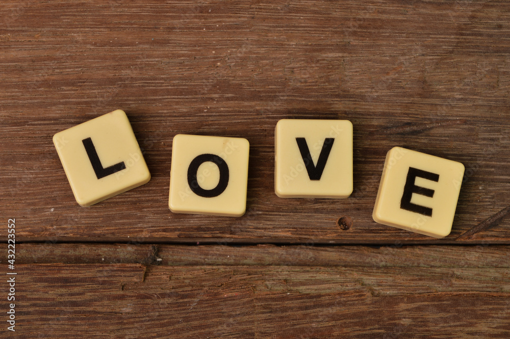 Top view of scrabble letters with text LOVE over wooden background Top view of scrabble letters with text LOVE over wooden background