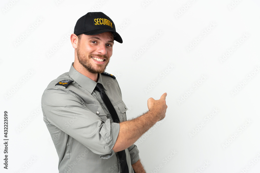 Young security Brazilian man isolated on white background pointing back Young security Brazilian man isolated on white background pointing back