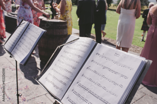 Sheet music diplayed at an outdoor drinks party or wedding photo
