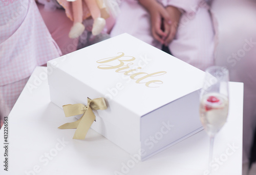 Bridal white and gold gift box with bride and champagne photo