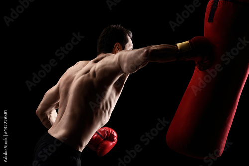 Topless man hitting a punching bag © Ljupco Smokovski