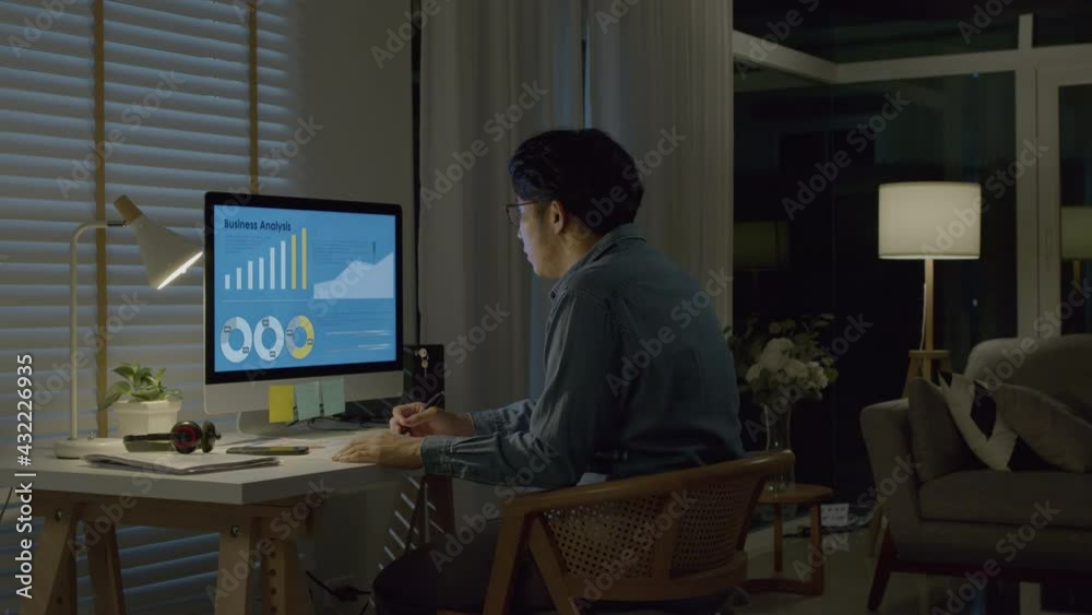 Asian man hard working at home,thinking and feeling thoughtful.Working from Home overload at night, self isolation in new normal concept.Working late and Overtime