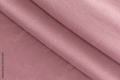 surface of soft knitted fabric for sewing clothes powdery pink, folded