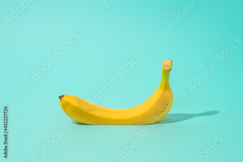 Summer cut fresh banana on bright blue background. Minimal fruit concept.