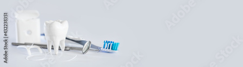 Tooth and brush on gray background