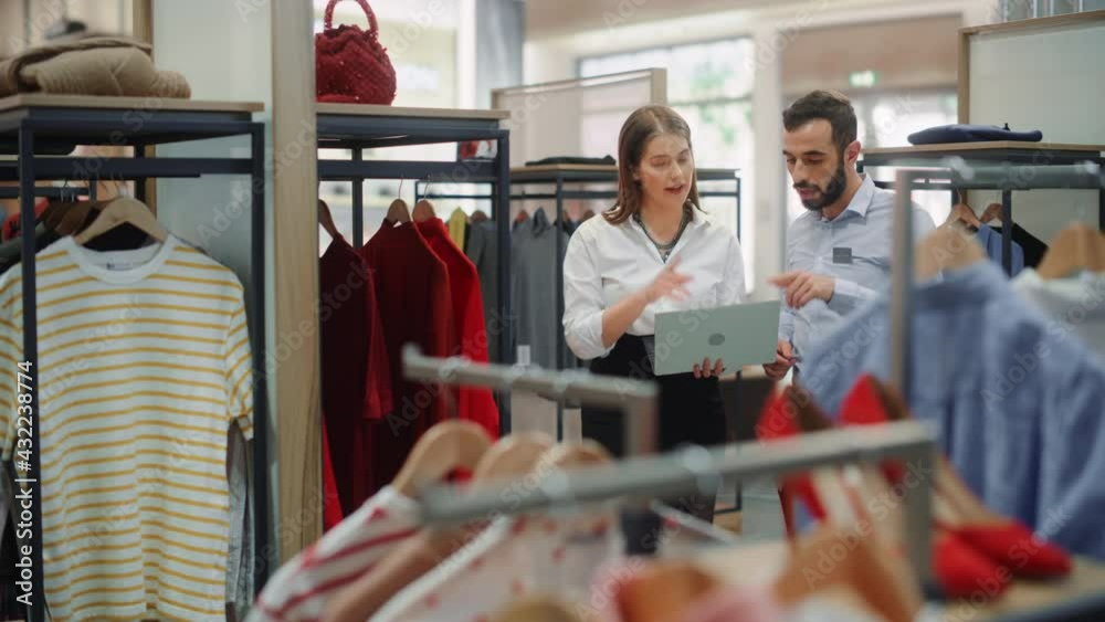 Clothing Store: Visual Merchandiser Talks to Sales Associate, Explains Strategy, Collection Visualization, Optimization of Customer Experience. Fashion Shop with Stylish, Trendy, Sustainable Brands