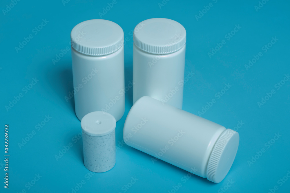 mockup white plastic jars on colored background.copy space. mockup white plastic jars on colored background.copy space.