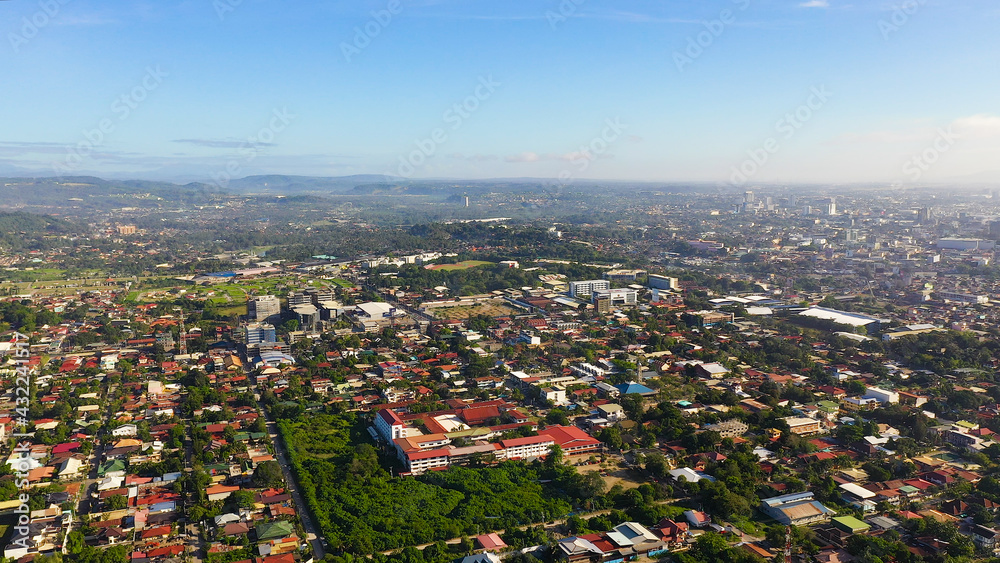 Davao city with modern buildings, business centers on the island of Mindanao view from above. Davao del Sur, Philippines.
