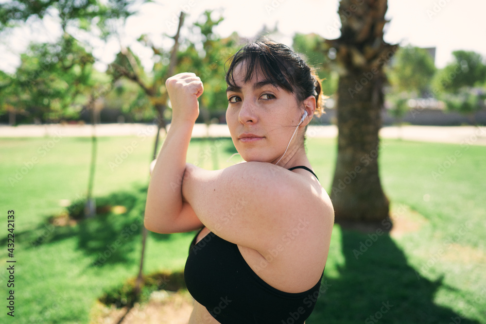 a beautiful white woman with brown hair exercises her arms to be ready for physical activity a beautiful white woman with brown hair exercises her arms to be ready for physical activity