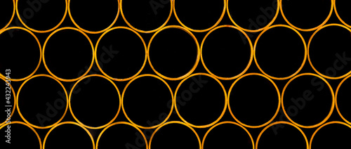 Pile of round industrial material polyethylene thermoplastic pipes on a construction site