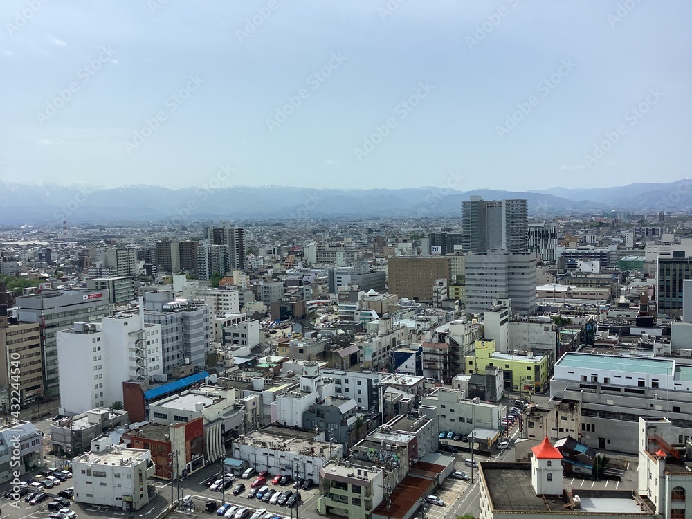 Naklejka premium Scenery of Toyama city and Tateyama mountain range seen from the observation deck of Toyama city