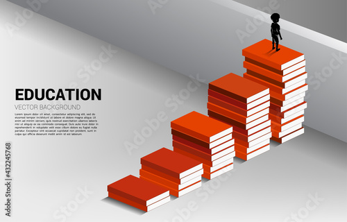 Concept background for power of knowledge. Silhouette of boy move to cross wall with step from book stack.