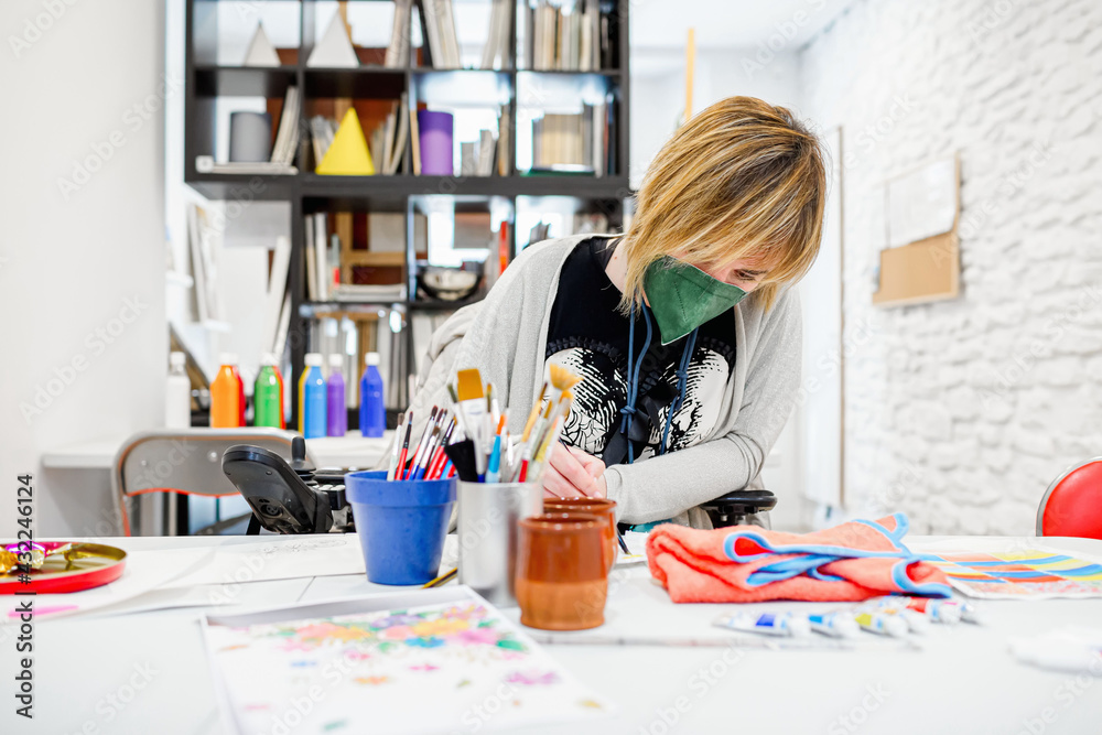 disabled woman in a wheelchair learning to paint