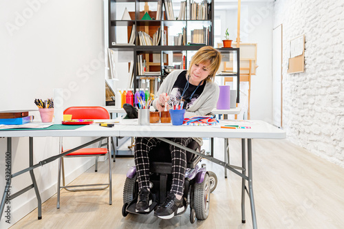 disabled woman in a wheelchair learning to paint