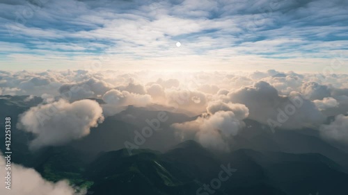 View of clouds over the mountains from a cockpit of a plane photo