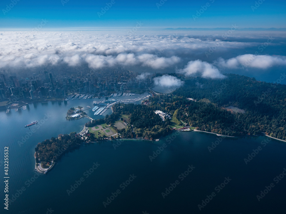Stock aerial photo of Stanley Park and downtown Vancouver with scattered clouds, Canada