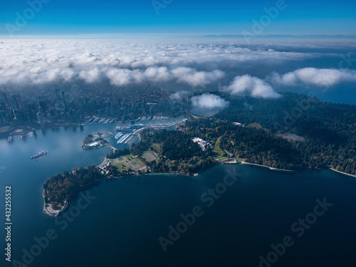 Stock aerial photo of Stanley Park and downtown Vancouver with scattered clouds, Canada