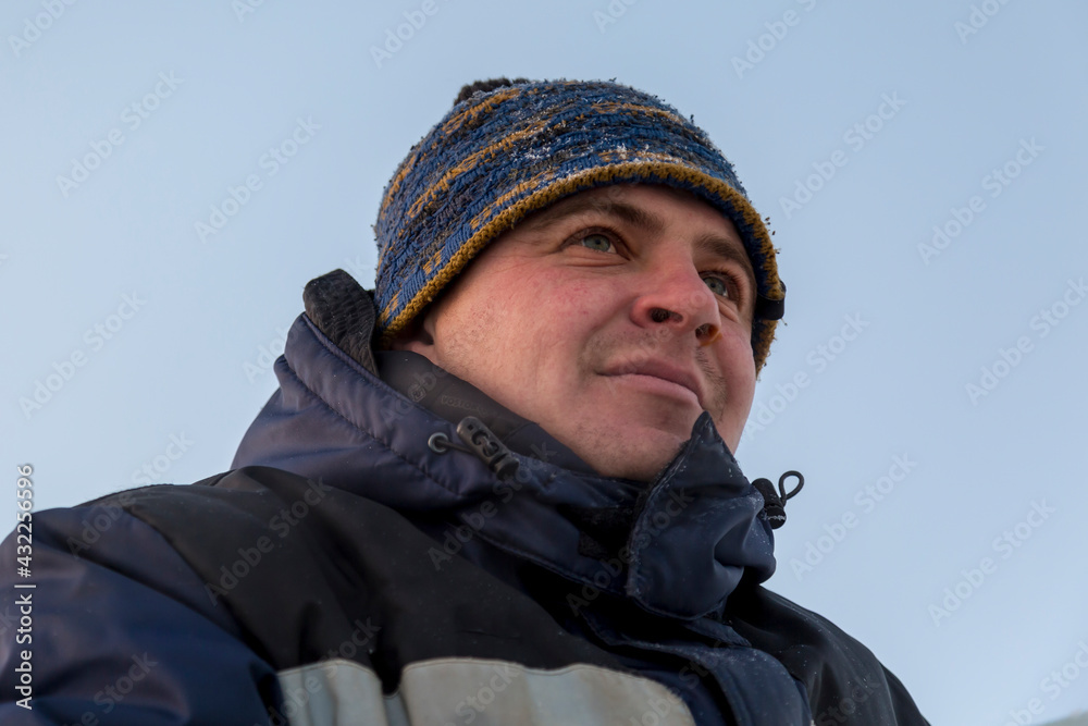 Portrait of a fitter in a blue jacket at a construction site Portrait of a fitter in a blue jacket at a construction site
