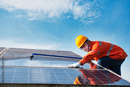Wallpaper Mural Asian technicians cleaning solar panels, technicians wearing masks to protect against germs. Torontodigital.ca