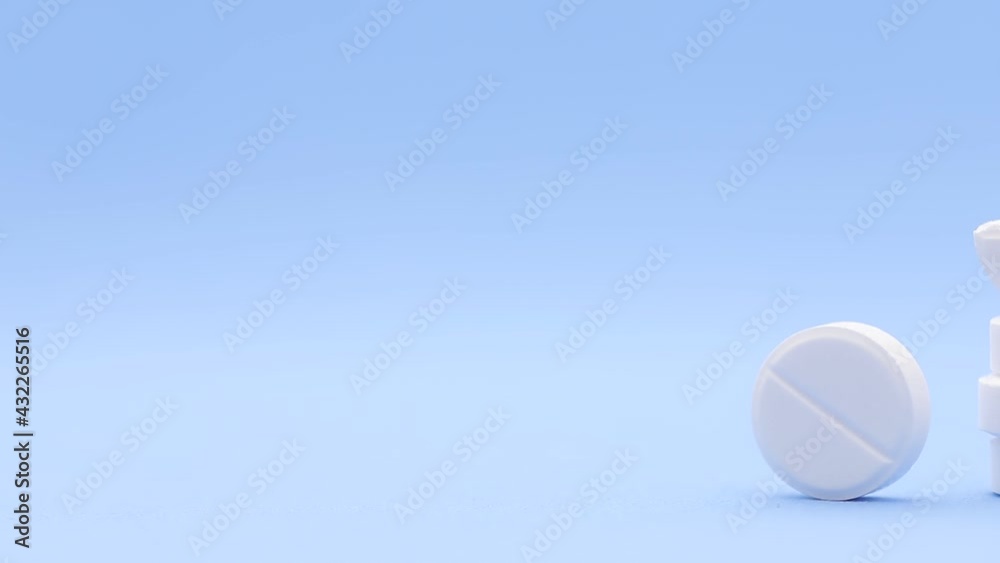 Pharmaceutical medical set of white pills stacked in the form of a tower on a blue background with copy space. Prescription medicine, antibiotic concept in round tablets with space for text close up. Pharmaceutical medical set of white pills stacked in the form of a tower on a blue background with copy space. Prescription medicine, antibiotic concept in round tablets with space for text close up.