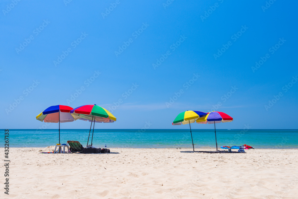 Sun umbrellas on Kamala beach on Phuket island in Thailand.
