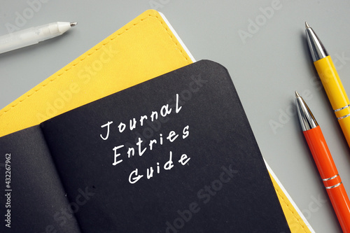  Financial concept meaning Journal Entries Guide with sign on the page.