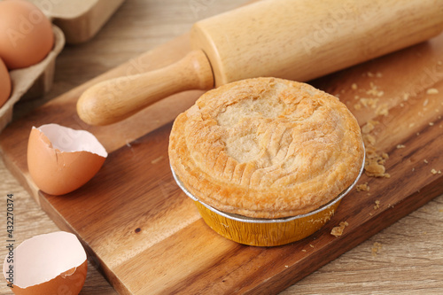 Meat pie on wooden tray