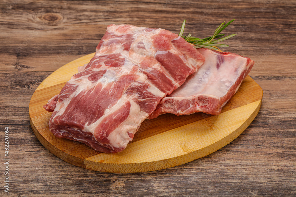 Raw pork ribs served rosemary