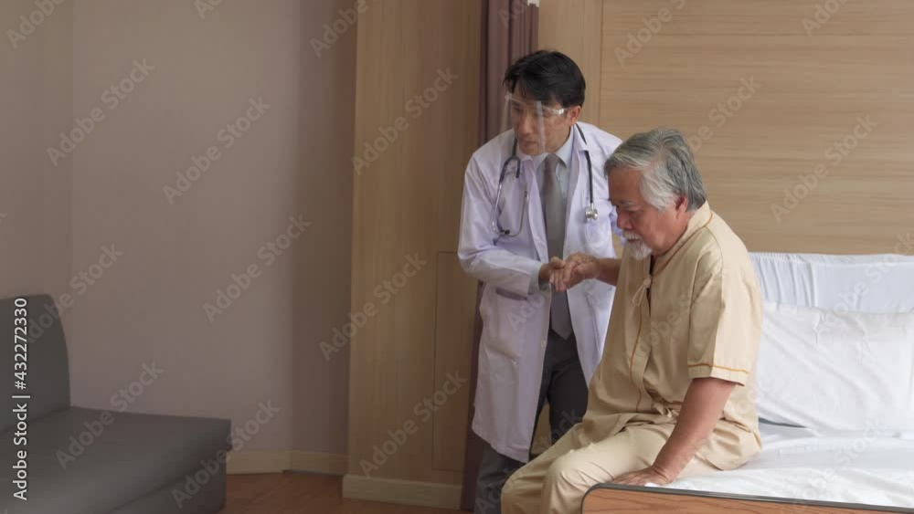 Asian male doctor and nurse help senior man patient sit on wheelchair to medical examination. Doctor recovery treatment to illness elderly male at hospital. Hospital and health care insurance concept. Asian male doctor and nurse help senior man patient sit on wheelchair to medical examination. Doctor recovery treatment to illness elderly male at hospital. Hospital and health care insurance concept.