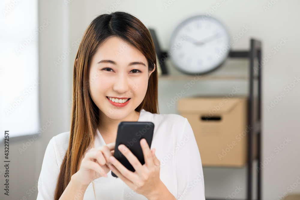 Young asian beautiful business woman using smartphone. Smiling charming happy young female texting touching on display of cell phone. Young asian beautiful business woman using smartphone. Smiling charming happy young female texting touching on display of cell phone.