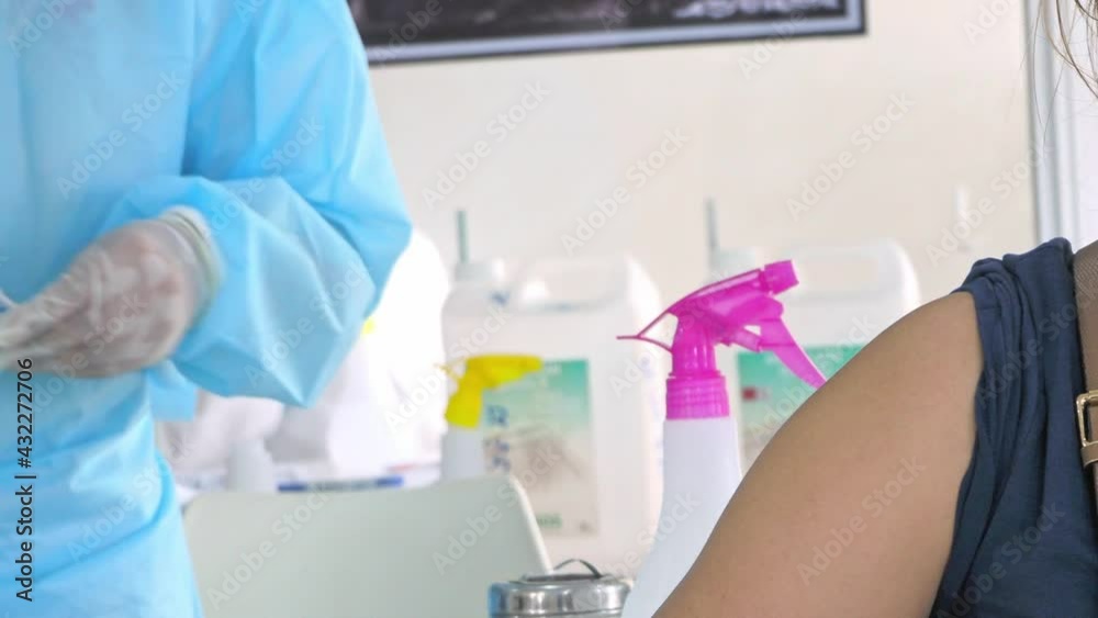 Medical staff preparing for a Covid vaccine injection -mid Medical staff preparing for a Covid vaccine injection -mid