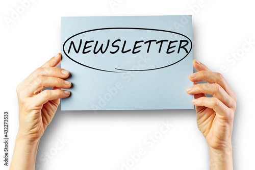 Woman's hands holding cardboard with the word Newletter inside a circle