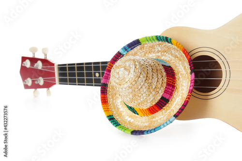 Mexican sombrero and guitar on white background