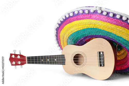 Mexican sombrero and guitar on white background