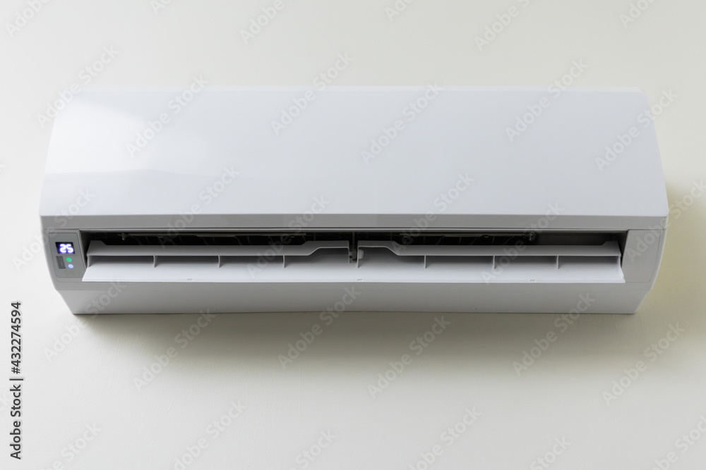 The air conditioner is hung on the wall of the house. For cooling in the living room of the house Make the air cool The air conditioner is hung on the wall of the house. For cooling in the living room of the house Make the air cool