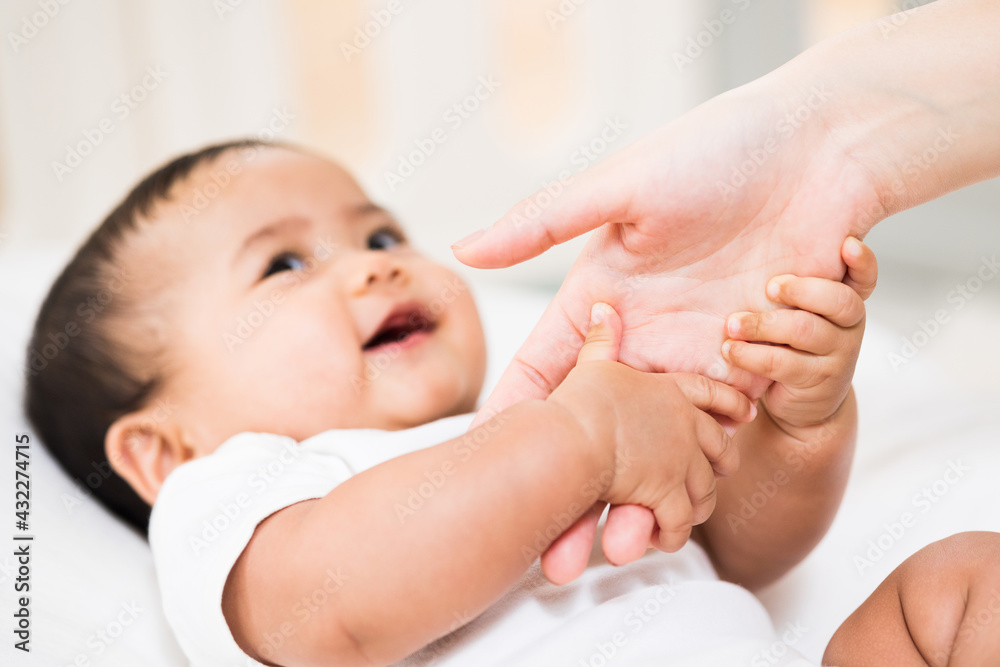 A cute baby wearing a white dress Stay with parents in the house Holding hands parents love family A cute baby wearing a white dress Stay with parents in the house Holding hands parents love family