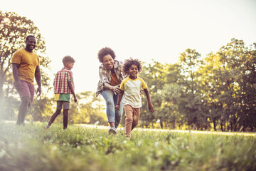 Cheerfully family.  African American family having fun outdoors.