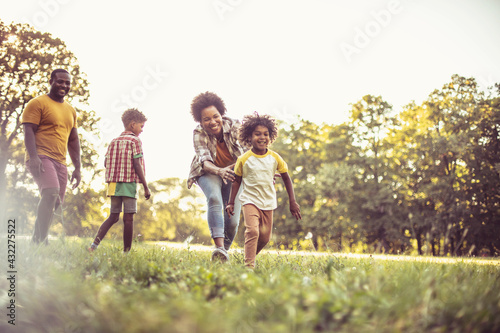 Cheerfully family.  African American family having fun outdoors.