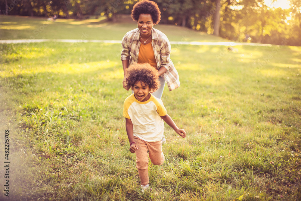 Fototapeta premium Mother and daughter running trough nature.