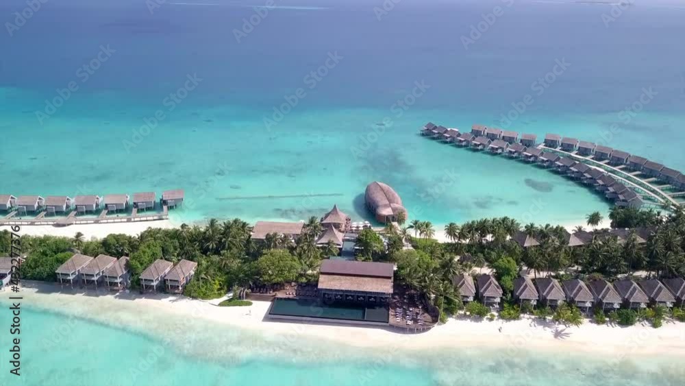 Aerial Tilt Down Shot Of Luxurious Resort Against Sky On Sunny Day, Drone Flying Forward Towards Hotel At Island - Kuramathi, Maldives