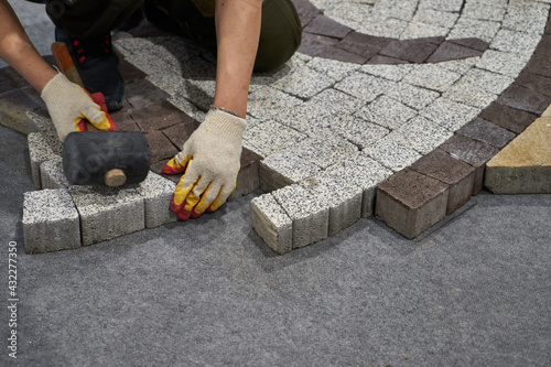 Master puts sidewalk tile.