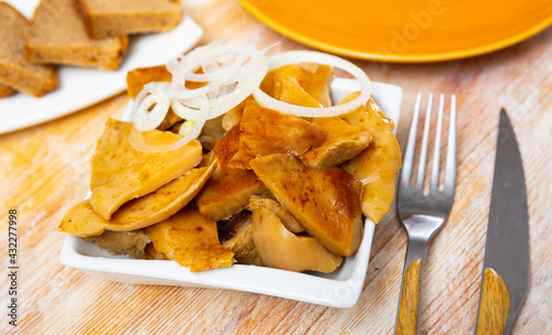 Appetizing pickled milk mushrooms with onion rings