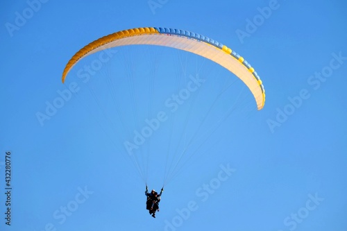 Tandem paragliding with bright sun at Pamukkale in the evening.