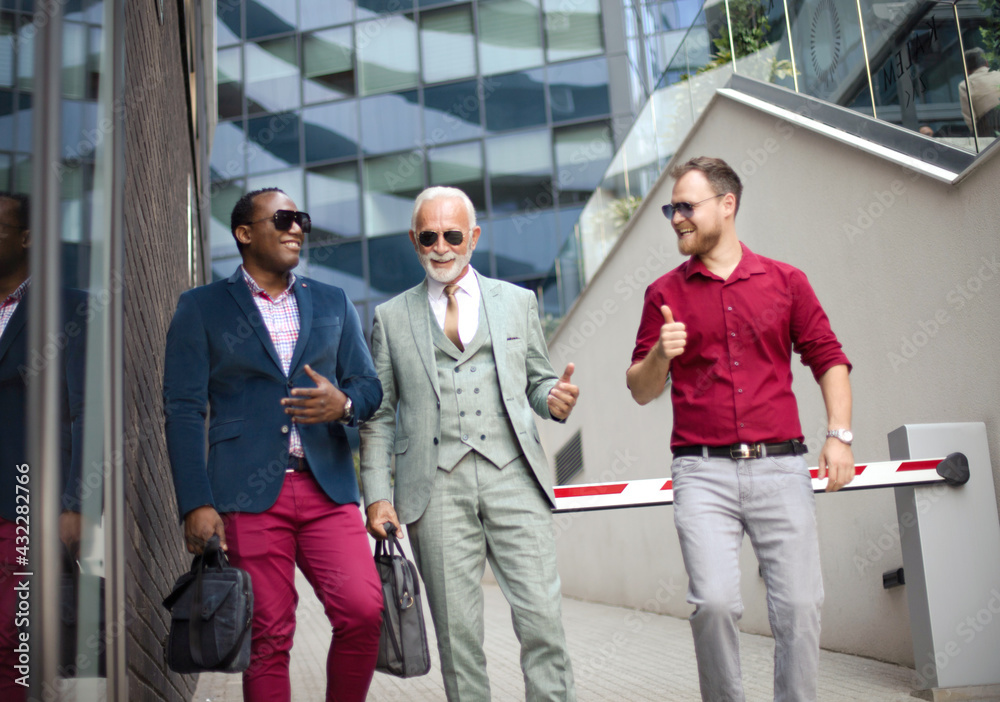 Three business men walking and talking outside. Three business men walking and talking outside.