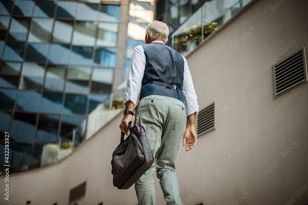 Senior business man walking trough street. Senior business man walking trough street.