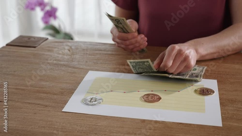 woman counts banknotes, income from bitkoin growth photo