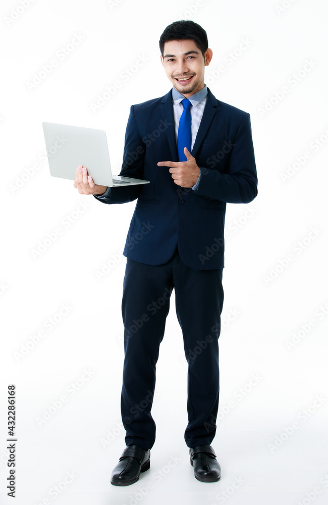 Smiling young Asian businessman shows laptop on isolated white background. Studio shot, business and success concept.