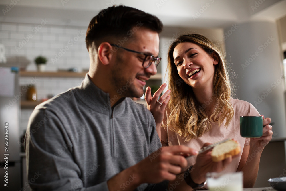 Husband and wife enjoying in breakfast. Loving couple drinking coffee in the kitchen.