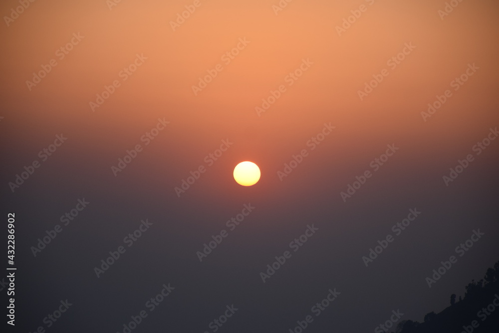 Orange big sun isolated on orange background. Sunset, Selective focus, Selective Focus On Subject, Background Blur Orange big sun isolated on orange background. Sunset, Selective focus, Selective Focus On Subject, Background Blur
