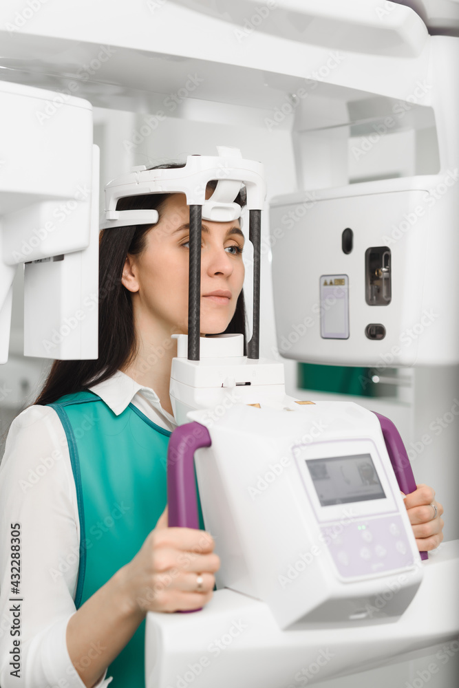 Young woman ready to computer 3d tomography of teeth and jaw in modern dental clinic Young woman ready to computer 3d tomography of teeth and jaw in modern dental clinic
